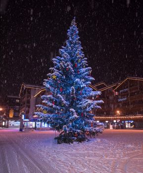 a view on snowy streets of the Alpine mountain village in the cold winter night