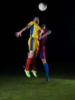 soccer player doing kick with ball on football stadium  field  isolated on black background