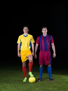 soccer player doing kick with ball on football stadium  field  isolated on black background