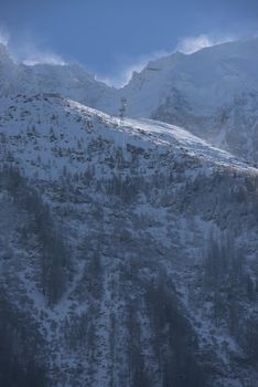 French alps mountain peaks covered with fresh snow. Winter landscape nature scene on beautiful sunny winter day.