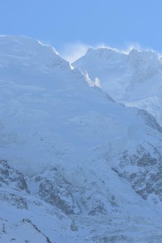 French alps mountain peaks covered with fresh snow. Winter landscape nature scene on beautiful sunny winter day.