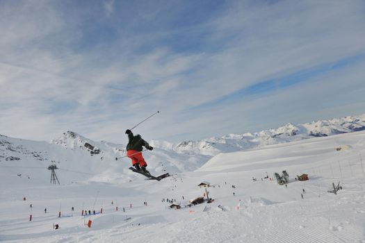 happy young man have fun at  mountain peak on winter season with beautiful sunset 