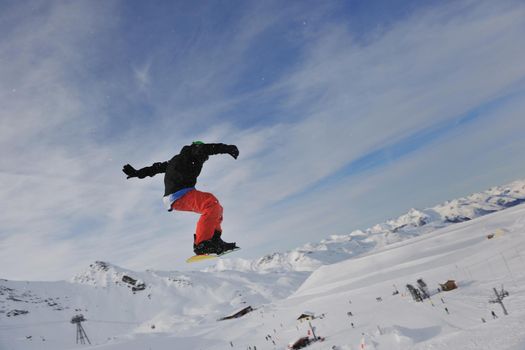 happy young man have fun at  mountain peak on winter season with beautiful sunset 