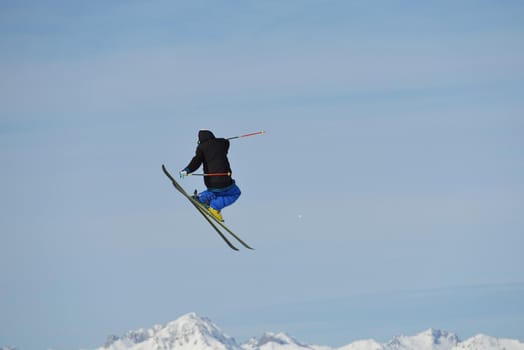 jumping skier at mountain winter snow fresh suny day