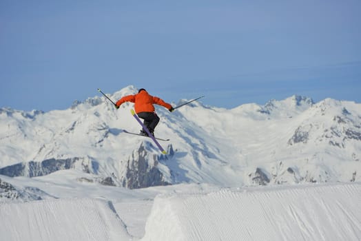 jumping skier at mountain winter snow fresh suny day