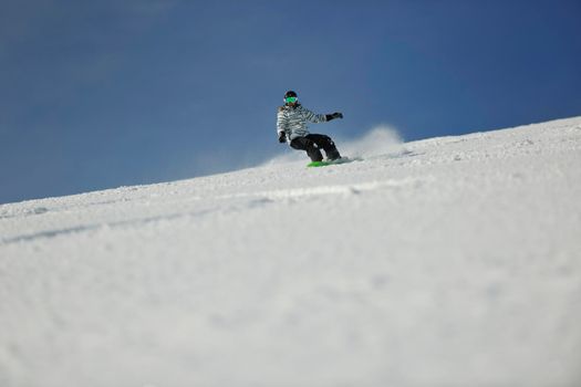 snowboard woman racing downhill slope and freeride on powder snow at winter season and sunny day