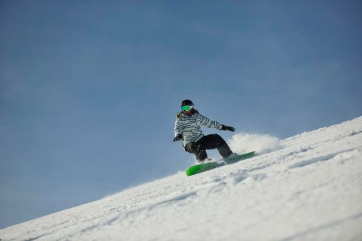 snowboard woman racing downhill slope and freeride on powder snow at winter season and sunny day