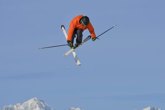 jumping skier at mountain winter snow fresh suny day