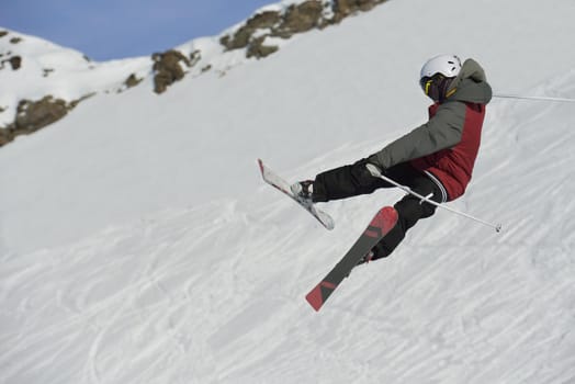 jumping skier at mountain winter snow fresh suny day