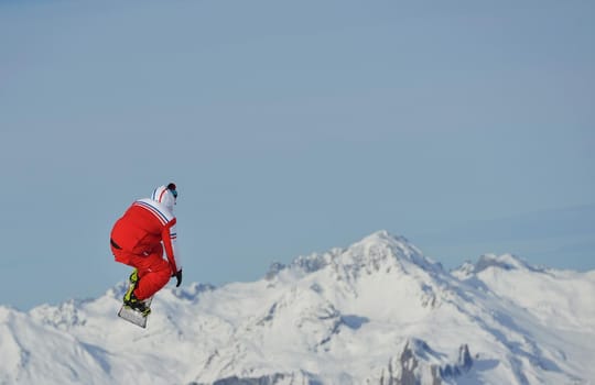 jumping skier at mountain winter snow fresh suny day