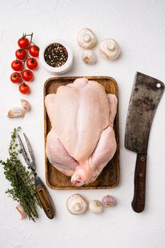 Chicken whole raw meat set, on white stone table background, top view flat lay