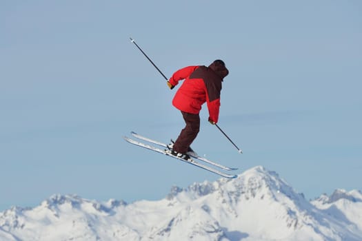 jumping skier at mountain winter snow fresh suny day