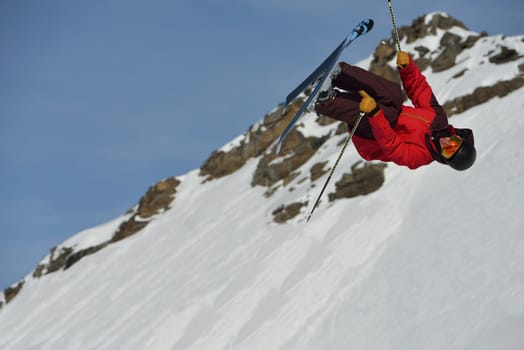 jumping skier at mountain winter snow fresh suny day