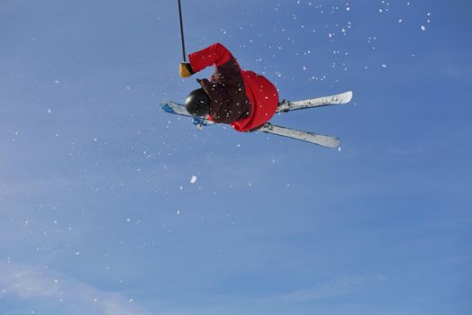 jumping skier at mountain winter snow fresh suny day