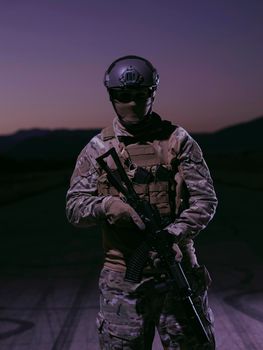 soldier with weapon and full military equioment  and combat gear in night mission