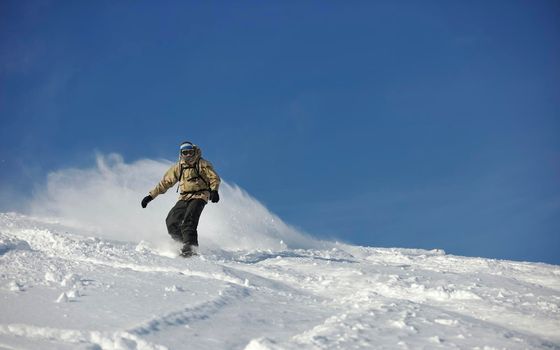 freestyle snowboarder jump and ride free style  at sunny winter day on mountain