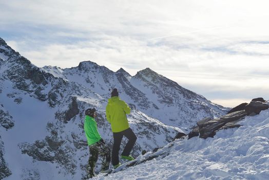 healthy people at top of mountain view at winter with fresh snow at beautiful sunny day