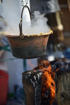 polenta food prepared on traditional recipe with fire and woods on height mountain alps at winter season at beautiful sunny day