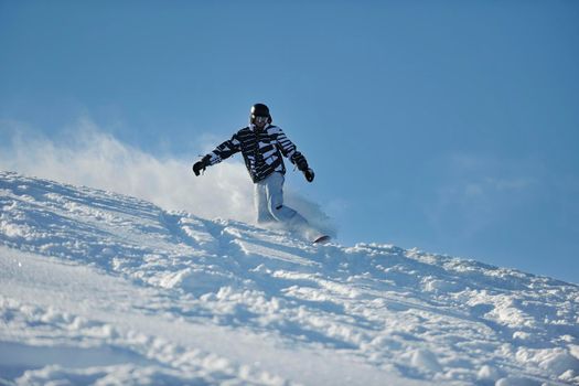 freestyle snowboarder jump and ride free style  at sunny winter day on mountain