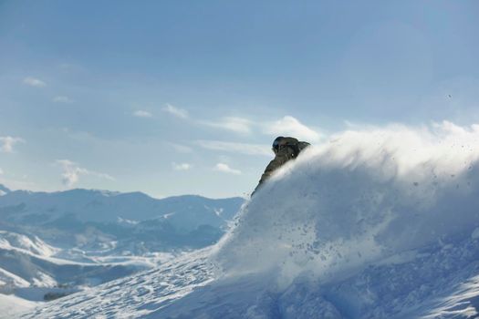 freestyle snowboarder jump and ride free style  at sunny winter day on mountain