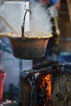 polenta food prepared on traditional recipe with fire and woods on height mountain alps at winter season at beautiful sunny day