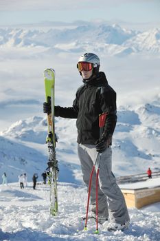 happy people group have fun on snow at winter season on mountain with blue sky and fresh air