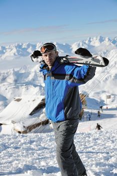 happy people group have fun on snow at winter season on mountain with blue sky and fresh air