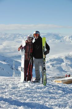 happy people group have fun on snow at winter season on mountain with blue sky and fresh air