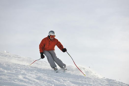 young athlete man have fun during skiing sport on hi mountain slopes at winter seasson and sunny day