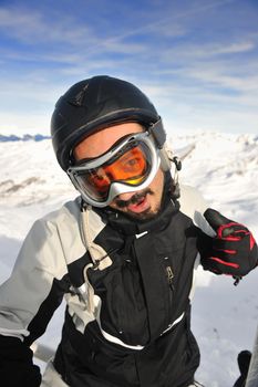 happy young man have fan while relaxing at snow with ski and snowboard sport at winter season