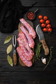 Raw uncooked chicken gizzards set, on black wooden table background, top view flat lay