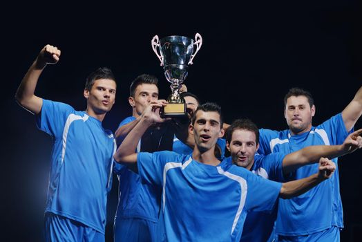 soccer players team group celebrating the victory and become champion of game while holding win coup