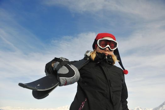 happy young woman have fan while relaxing at snow with ski and snowboard sport at winter seasonyoung healthy woman skiing on fresh snow at winter season in france alps