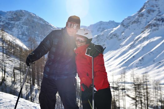 happy people group have fun on snow at winter season on mountain with blue sky and fresh air