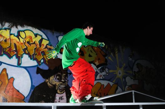 young free style snowboarder jumping in air and make acrobations