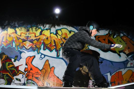 young free style snowboarder jumping in air and make acrobations