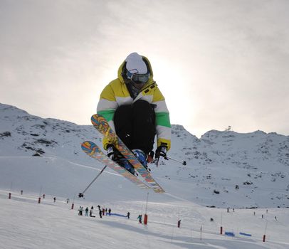 extreme freestyle ski jump with young man at mountain in snow park at winter season