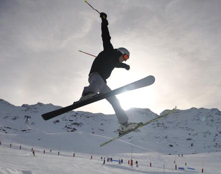 extreme freestyle ski jump with young man at mountain in snow park at winter season