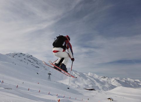 extreme freestyle ski jump with young man at mountain in snow park at winter season