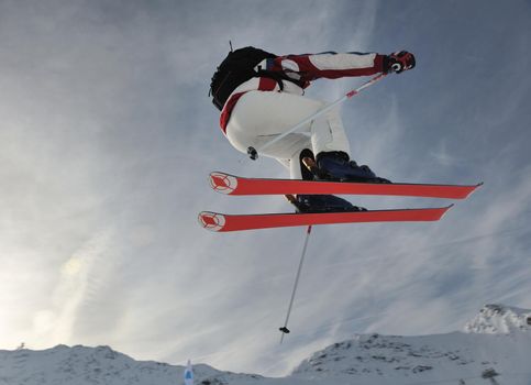 extreme freestyle ski jump with young man at mountain in snow park at winter season