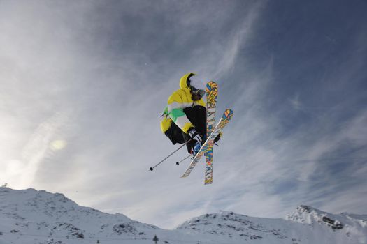 extreme freestyle ski jump with young man at mountain in snow park at winter season