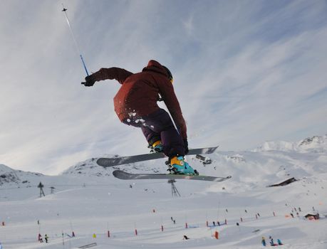 extreme freestyle ski jump with young man at mountain in snow park at winter season