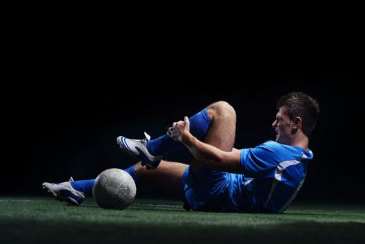 soccer player doing kick with ball on football stadium  field  isolated on black background