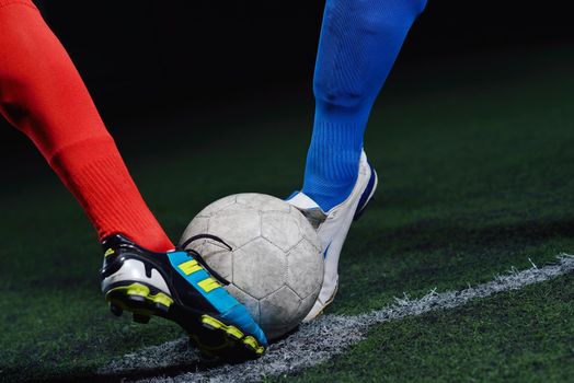 soccer player doing kick with ball on football stadium  field  isolated on black background