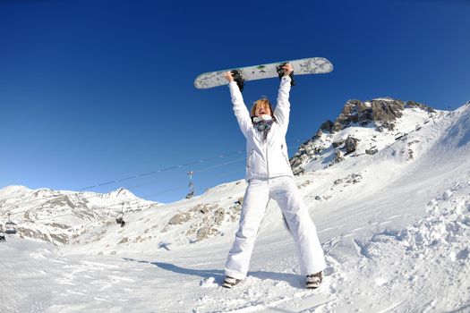 skiing downhill on fresh powder snow  with sun and mountains in background