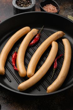 Raw frankfurter sausages set, on old dark rustic table background