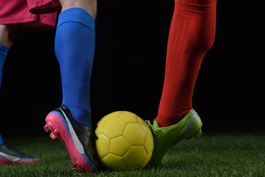 soccer player doing kick with ball on football stadium  field  isolated on black background