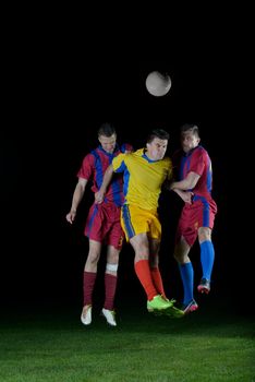 soccer player doing kick with ball on football stadium  field  isolated on black background