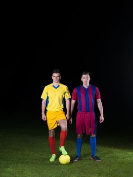 soccer player doing kick with ball on football stadium  field  isolated on black background