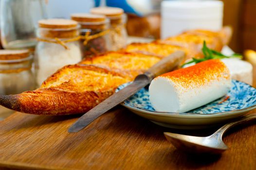 French cheese and fresh  baguette on a wood cutter